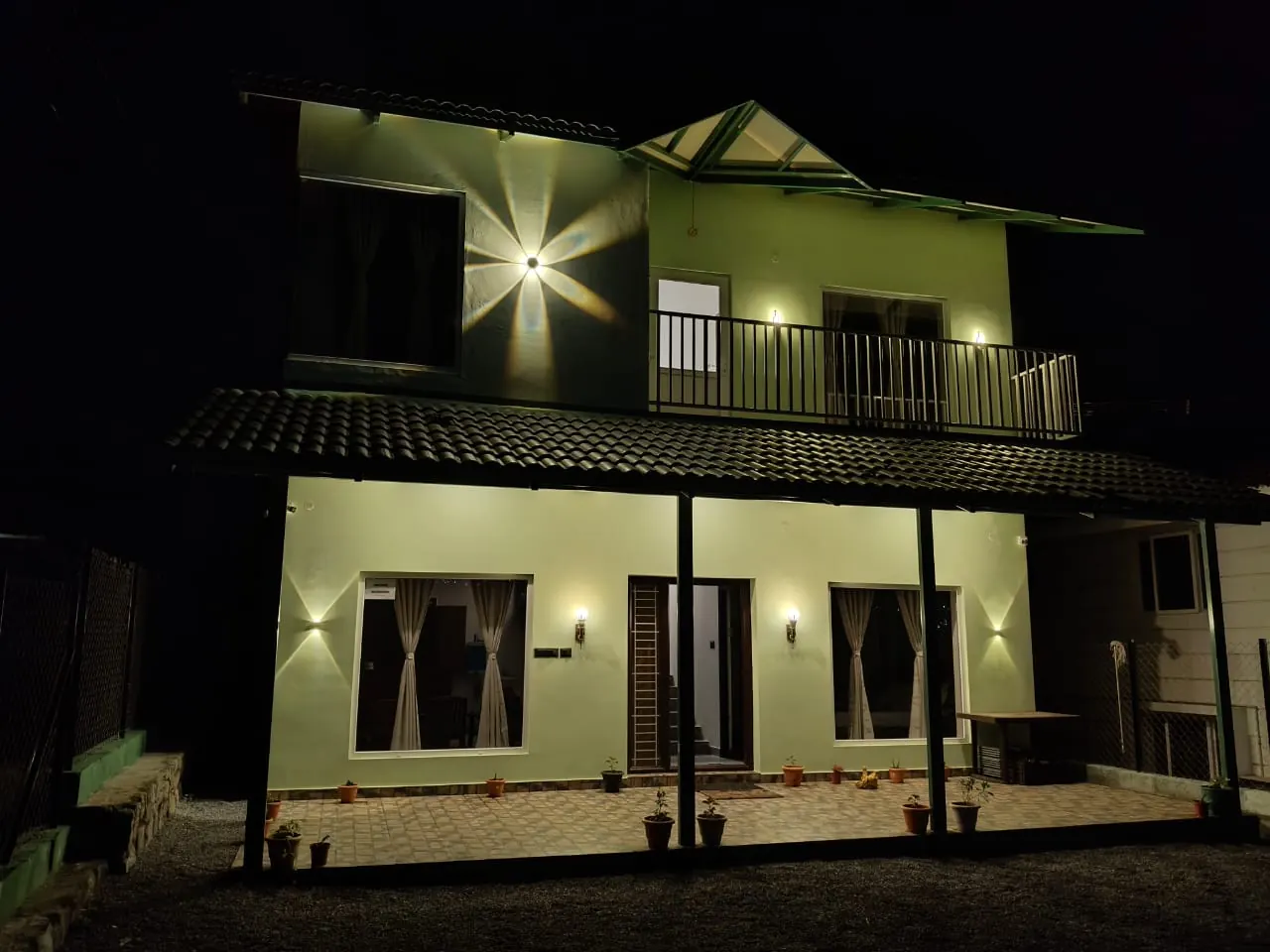 The 3 BHK villa lit up at night